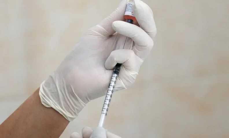 Vacina sendo segurada